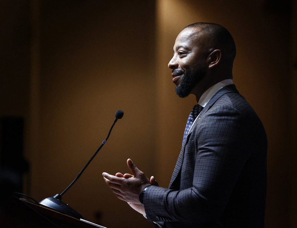 Mickell Lowery speaking at a podium